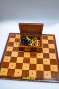 A travel chess set, with carved wood pieces,