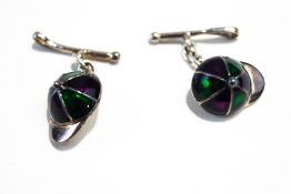 A pair of jockey cap cufflinks, colour decorated with resin, riding crop back link,