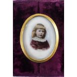 A Victorian portrait miniature of a young girl, hand painted over a base printed on bisque,