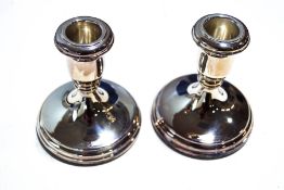 A pair of silver modern short round candlesticks by R Carrs, hallmarked for Sheffield 2005, 10.