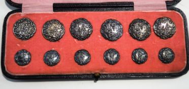 A matching set of six silver coat buttons and six blouse buttons, by Levi & Salaman,