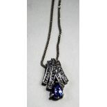 A 9 carat white gold tanzanite and diamond pendant,