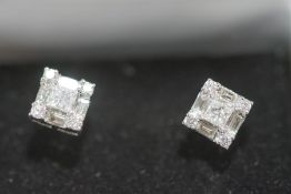 A pair of diamond stud earrings,