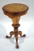 A Victorian walnut sewing/games table with inlaid decoration and games board to the top,