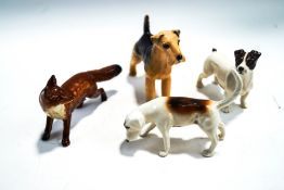 Four Beswick figures of a fox, a hound, a Jack Russell and an Airedale Terrier,