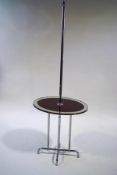 A chrome standard lamp with oval mirrored and red glass shelf, on an 'X' base,