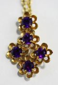 A 9 carat gold amethyst pendant, the five stones to five flowerhead motifs, on a chain,