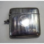 A silver vesta case, by Walker & Hall, Chester 1920, with linear engine turned decoration,