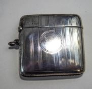 A silver vesta case, by Walker & Hall, Chester 1920, with linear engine turned decoration,