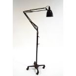 An Anglepoise floor lamp on a four pronged base with casters