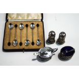 A four piece silver cruet, comprising two salts and two peppers,