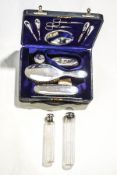 A silver travelling toilet set, Birmingham 1923, comprising, a mirror, hair brush, clothes brush,