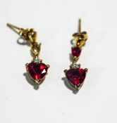 A pair of synthetic ruby and diamond drop earrings
