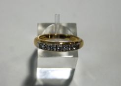A seven stone diamond 18 carat gold half hoop ring,