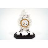 A porcelain mantel clock with white enamel dial signed Howell James & Co.