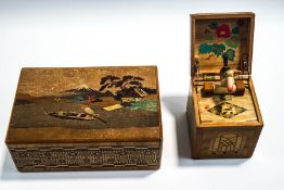 A Japanese puzzle box, with pictorial scene of Mount Fuji and figures in a boat, 23cm x 15cm,