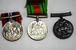 A 1914-1918 War medal, a WWII War medal and Defence medal, unnamed but wth box addressed to W.G.