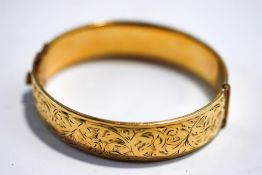 A rolled gold hinged bangle