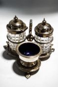 A Victorian silver trefoil cruet stand with beaded borders, a scroll handle, on three palmette feet,