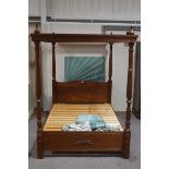 A Victorian style mahogany four poster bed, with patterned and duck egg blue drapes,
