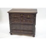 A 17th Century oak chest of four long drawers, with applied geometric mouldings, on bun feet,