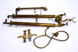 A pair of Victorian brass bath taps with shower attachment,