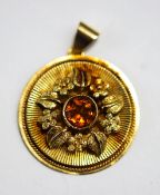 A citrine set pendant, to an disc shaped mount with engine turning and floral decoration, 2.