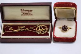 An Edwardian pendant, stamped '9ct', on a metal chain; with a 9 carat gold garnet cluster ring,