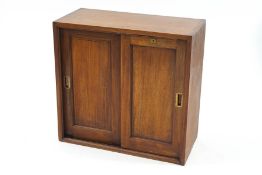 An early 20th Century Hobbs & Co mahogany cabinet with sliding doors, enclosing four shelves, 77.