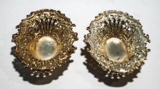 A pair of small Edwardian silver pierced and embossed shaped-oval dishes,