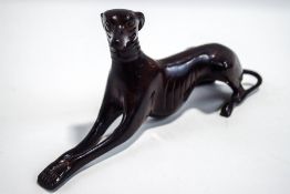 A 20th Century bronze model of a recumbent greyhound,