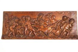 A Continental carved panel with putti, dogs and other animals, pulling a cart,