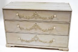A Victorian pine chest of three drawers with gesso floral decoration,