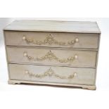 A Victorian pine chest of three drawers with gesso floral decoration,