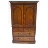 A Victorian mahogany linen press, with plain cornice above two panelled doors,