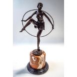 An Art Deco style bronze, modelled as a semi nude dancing girl holding a hoop, after D.