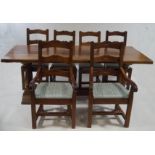 An oak refectory style dining table, with six turned baluster supports upon a scroll end base,
