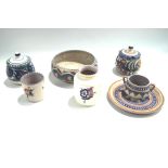 A collection of Poole Pottery with floral and geometric patterns,