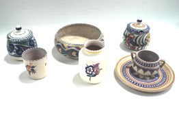 A collection of Poole Pottery with floral and geometric patterns,