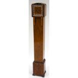 An Art Deco walnut veneered Grandmother clock, with three train movement,