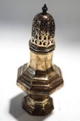 A silver octagonal baluster shaped sugar caster, the pierced cover with a baluster finial,