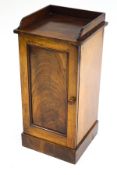 A Victorian mahogany pot cupboard with a figured panelled door,