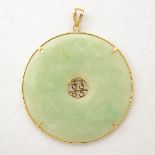 Jade, 14k Yellow Gold Pendant. Featuring a carved jadeite disc pi measuring approximately 49.4 mm,