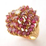 Diamond, Ruby, 18k Yellow Gold Ring. Centering one full-cut diamond weighing approximately 0.15 ct.,