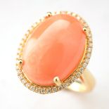 *Coral, Diamond, 14k Yellow Gold Ring. Centering one oval coral cabochon measuring approximately