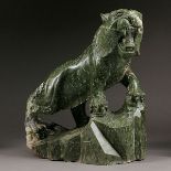 A Green Hardstone Figure of a Tiger The noble roaring beast climbing a rocky hill. {Height: 31