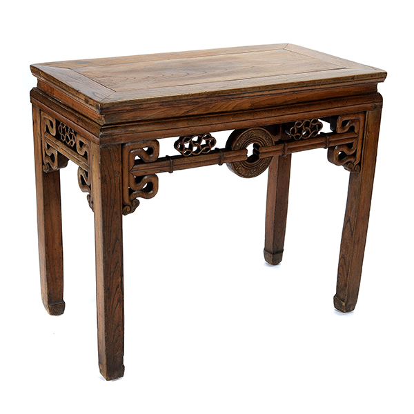 An Elmwood Side Table The rectangular table set with a single-panel top, the openwork aprons