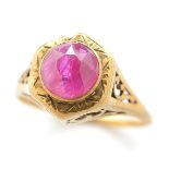 Ruby, 10k Yellow Gold Ring. Centering one round-cut ruby, set in an open work 10k yellow gold ring