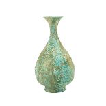 A Korean Bronze Bottle Vase Of pear shape rising to a flaring mouth, covered in a green patina.