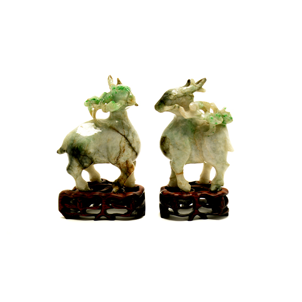 A Pair of Jadeite Figures of Deer Carved in mirror image with each deer grasping a lingzhi branch in